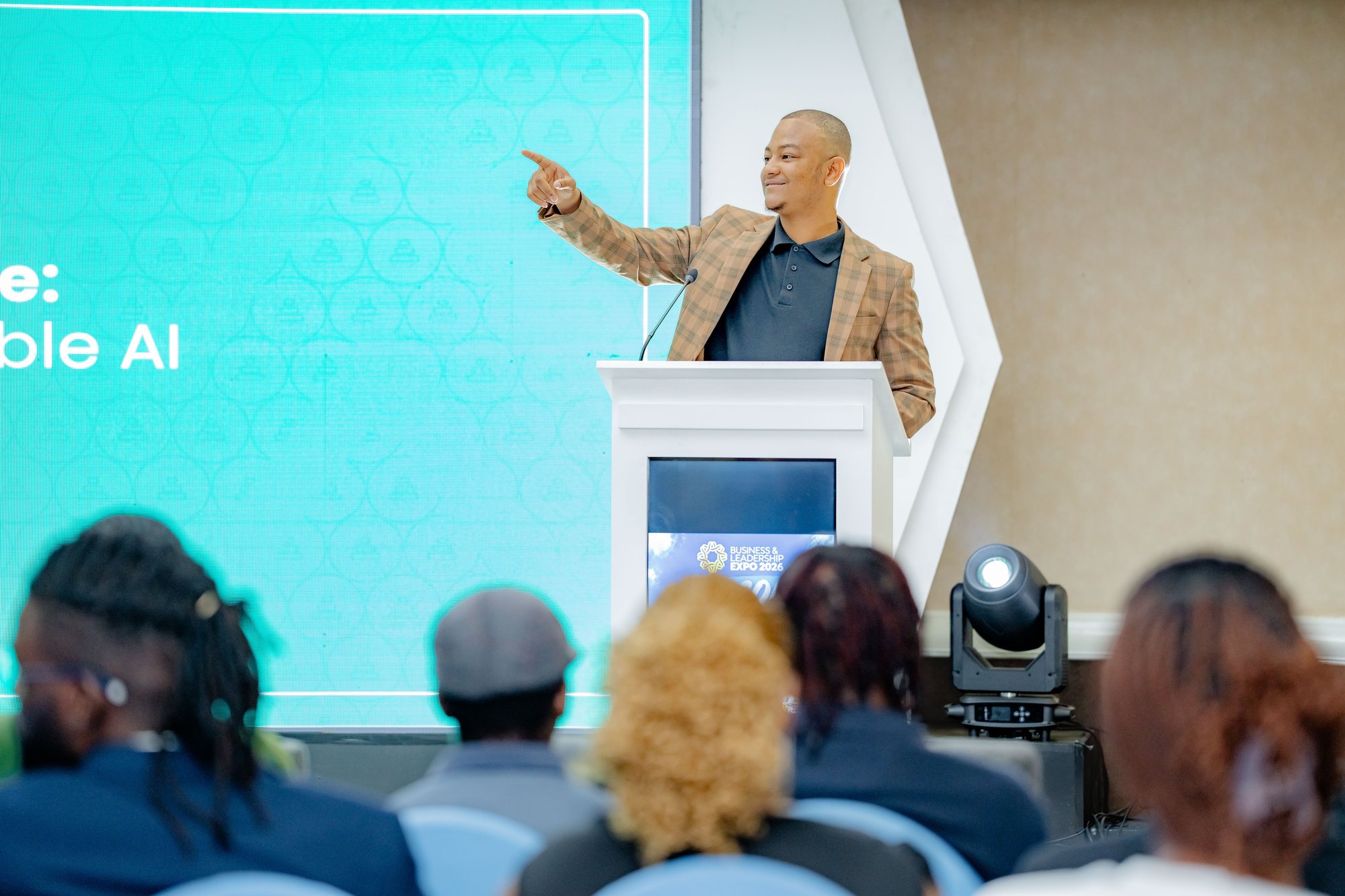 Maverick Kabelo pointing to a slide on responsible AI while speaking at the Expo